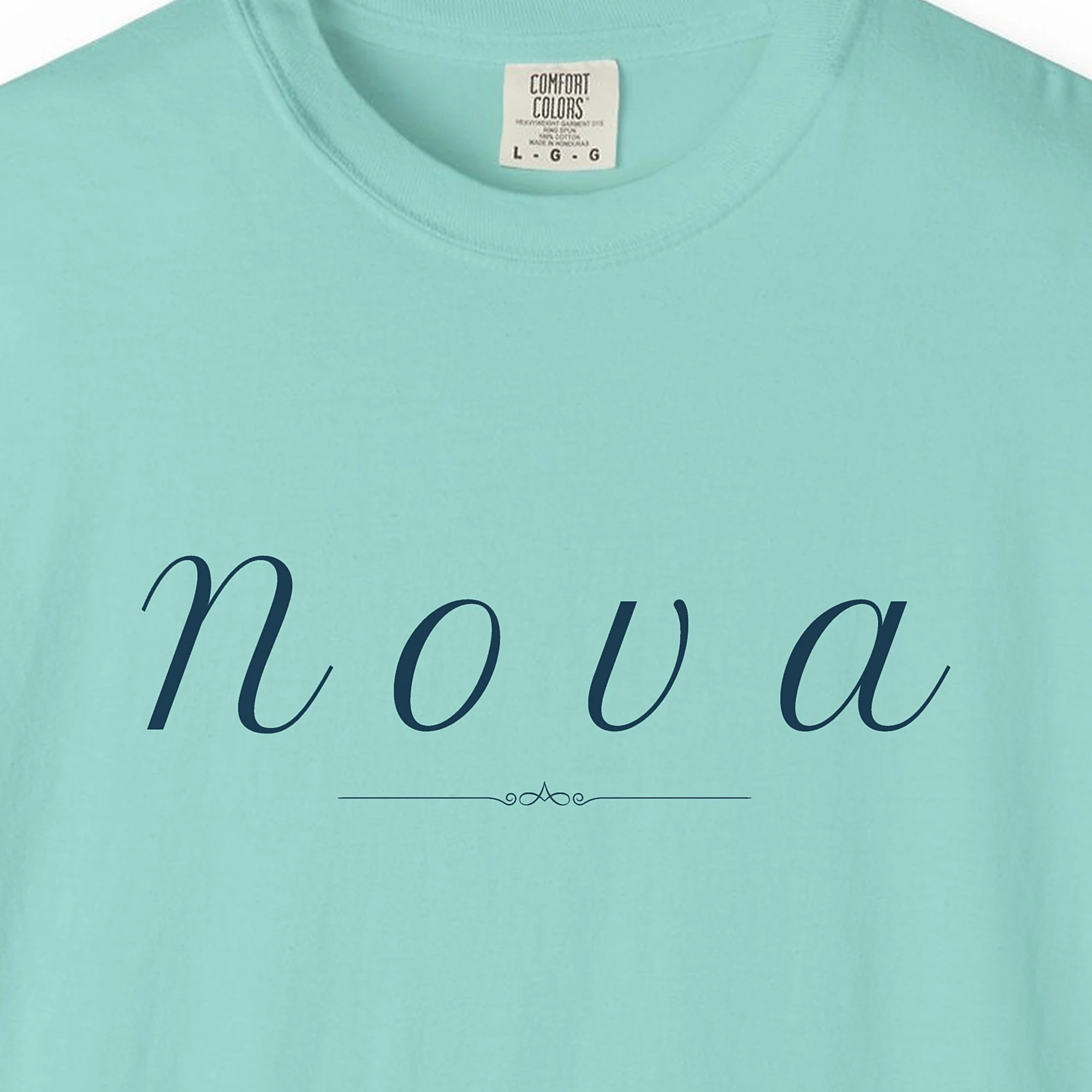 Close-up of the Nova Italic print on a Chalky Mint Comfort Colors 1717 tee