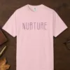 Nurture design on a Blossom Comfort Colors 1717 tee, laid flat