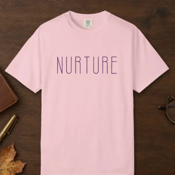 Nurture design on a Blossom Comfort Colors 1717 tee, laid flat