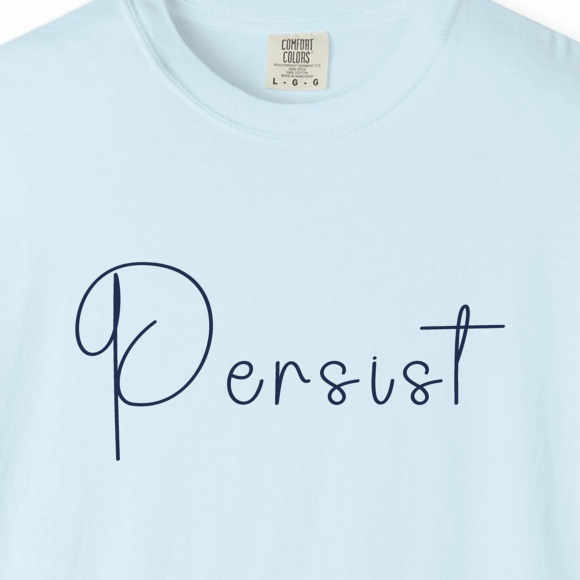 Close-up of the Persist print on a Chambray Comfort Colors 1717 tee