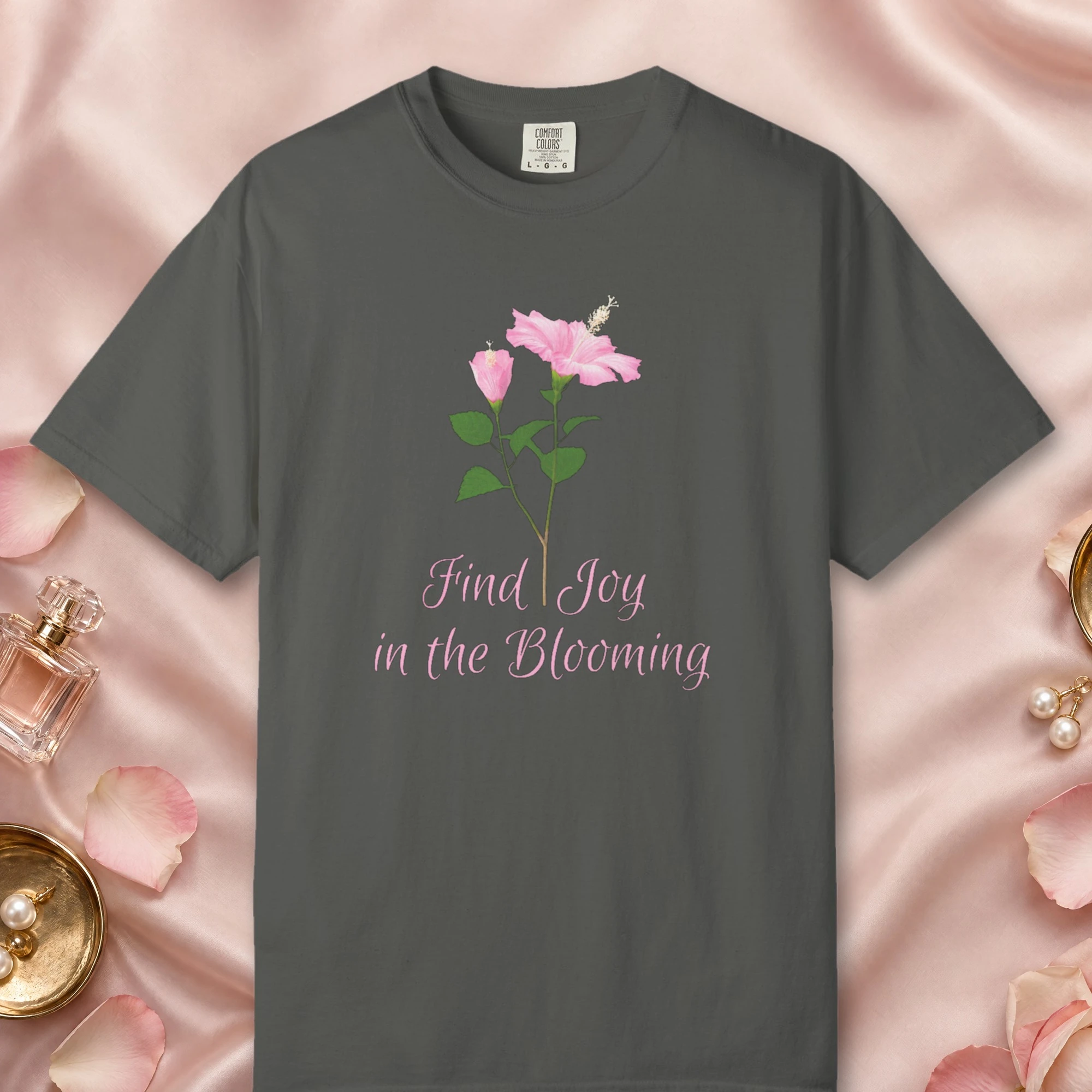 Pink Hibiscus Joy design on a Pepper Comfort Colors 1717 tee, laid flat