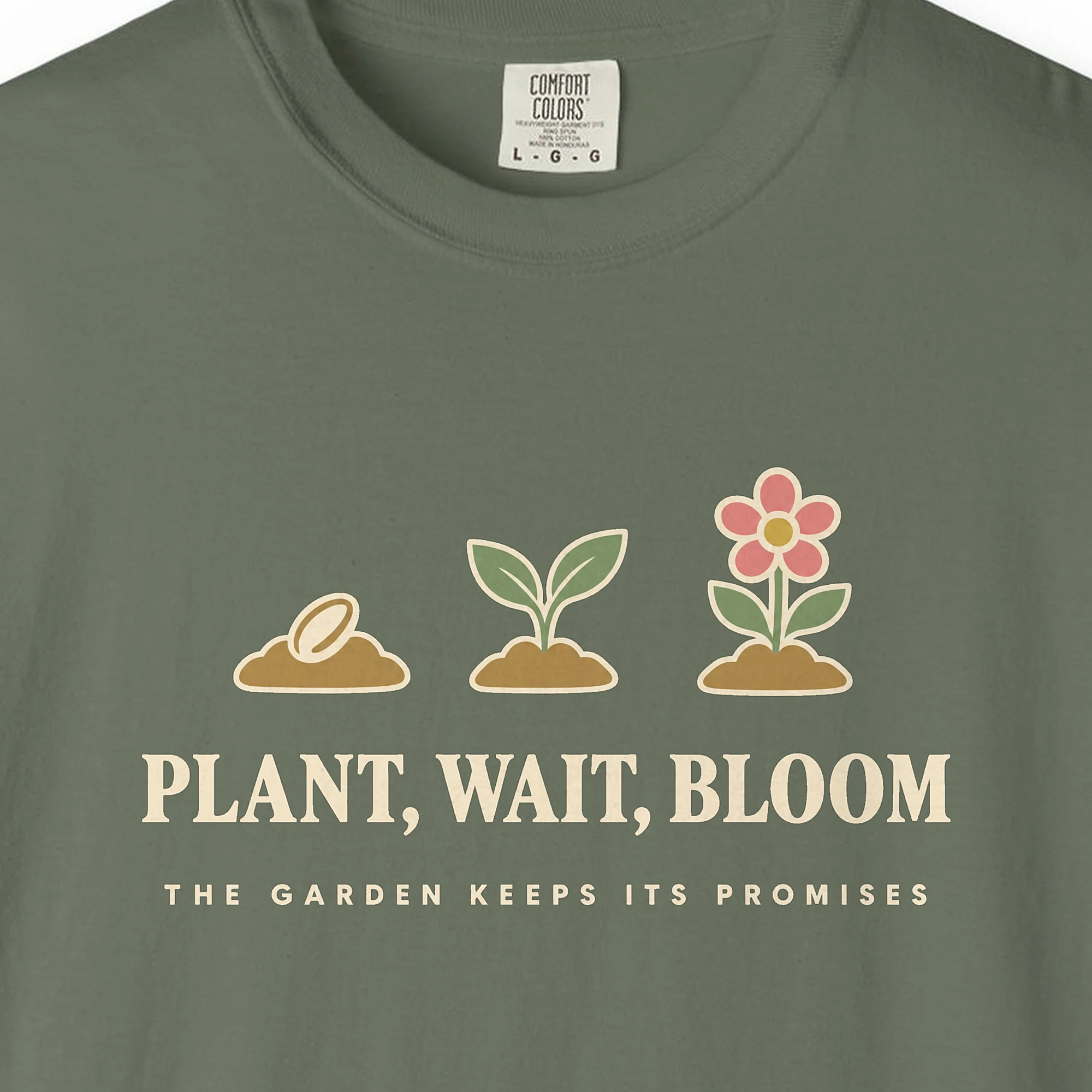 Close-up of the Plant Wait Bloom print on a Moss Comfort Colors 1717 tee