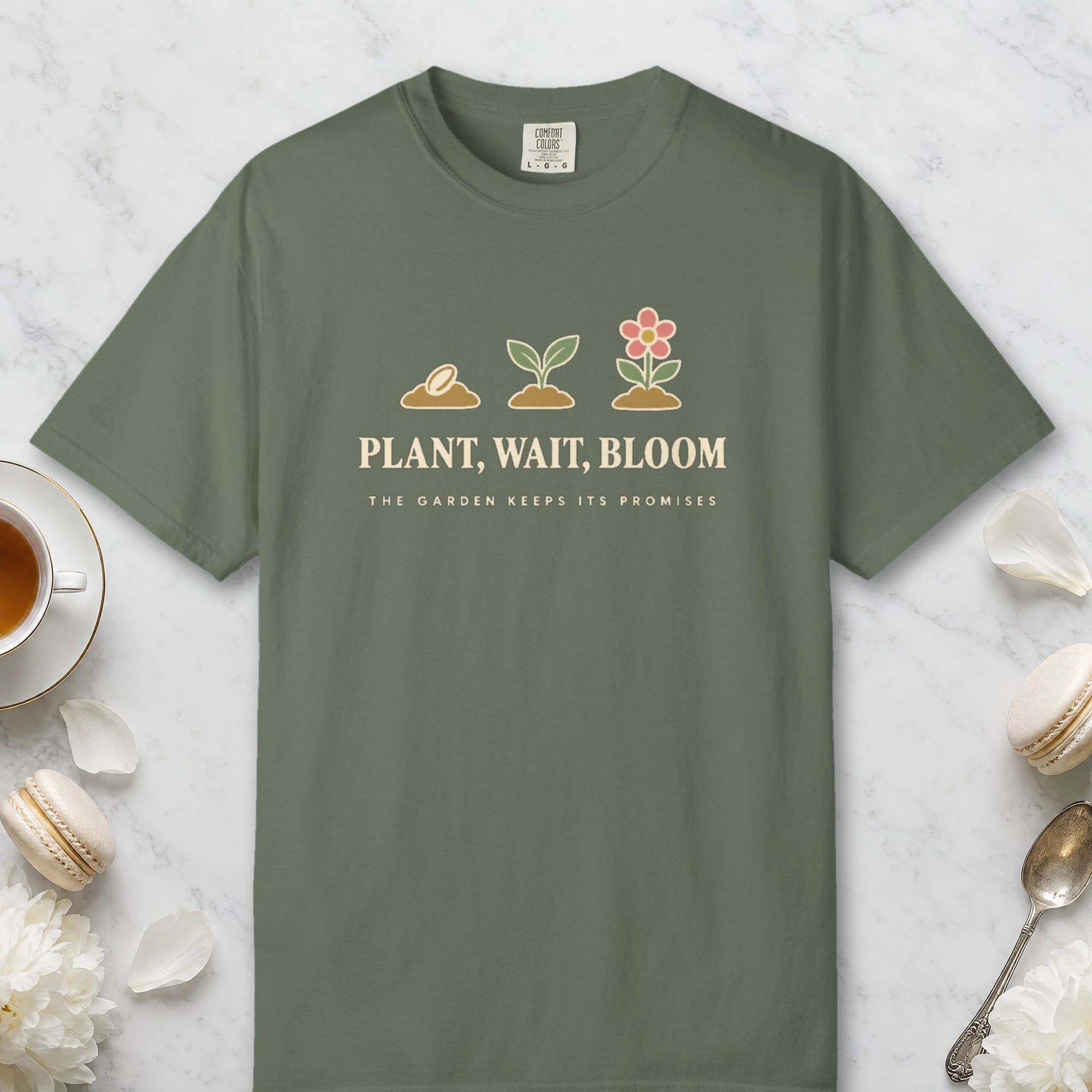 Plant Wait Bloom design on a Moss Comfort Colors 1717 tee, laid flat