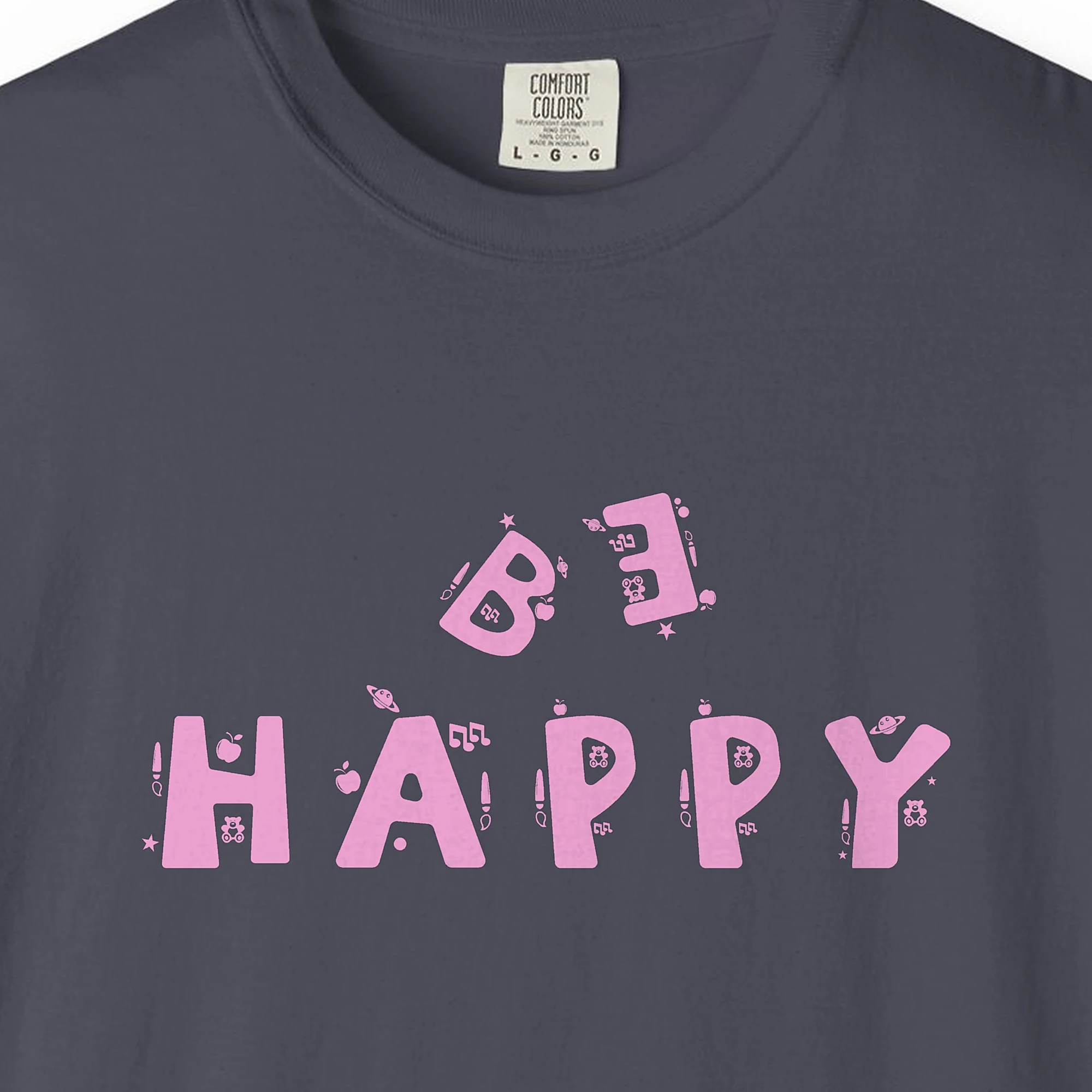 Close-up of the Playful Happiness print on a Navy Comfort Colors 1717 tee