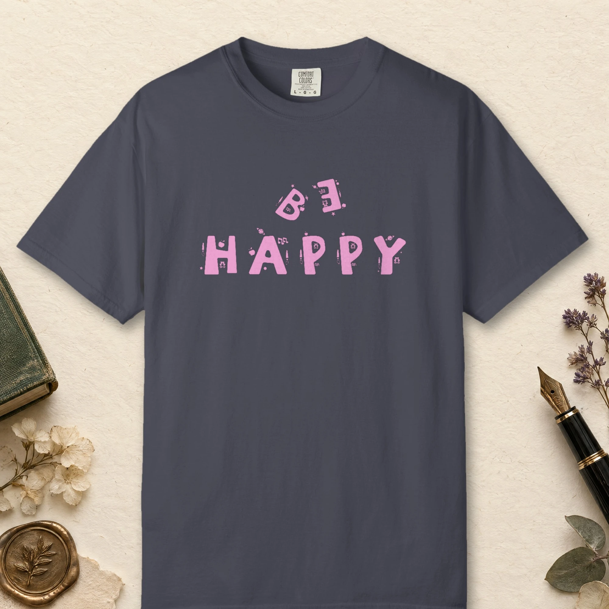 Playful Happiness design on a Navy Comfort Colors 1717 tee, laid flat