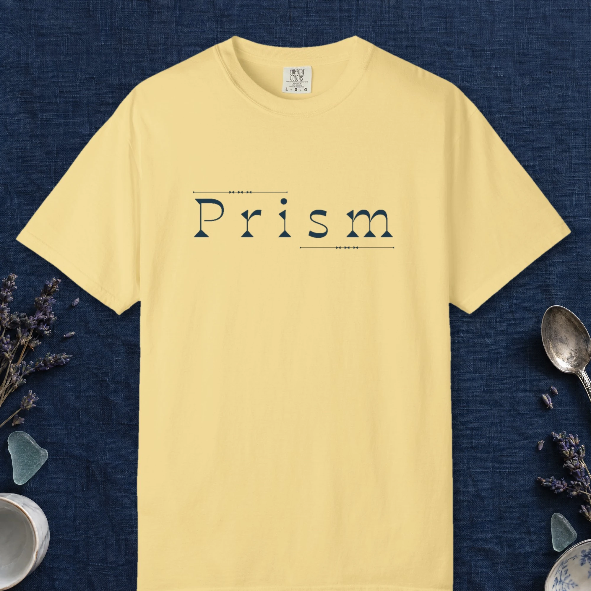 Prism Slab Serif design on a Butter Comfort Colors 1717 tee, laid flat