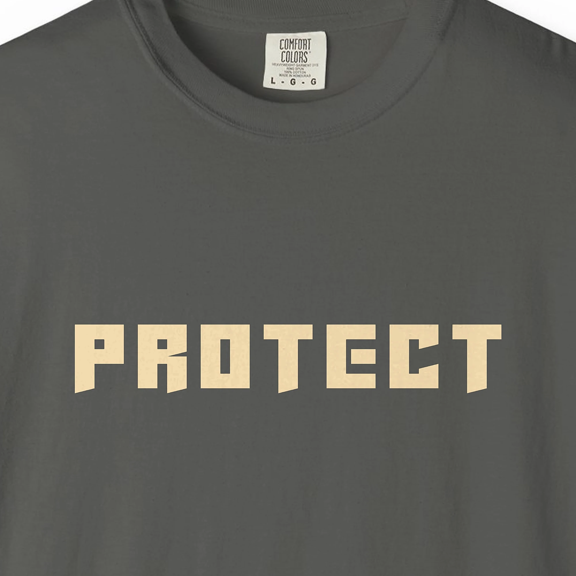 Close-up of the Protect print on a Pepper Comfort Colors 1717 tee