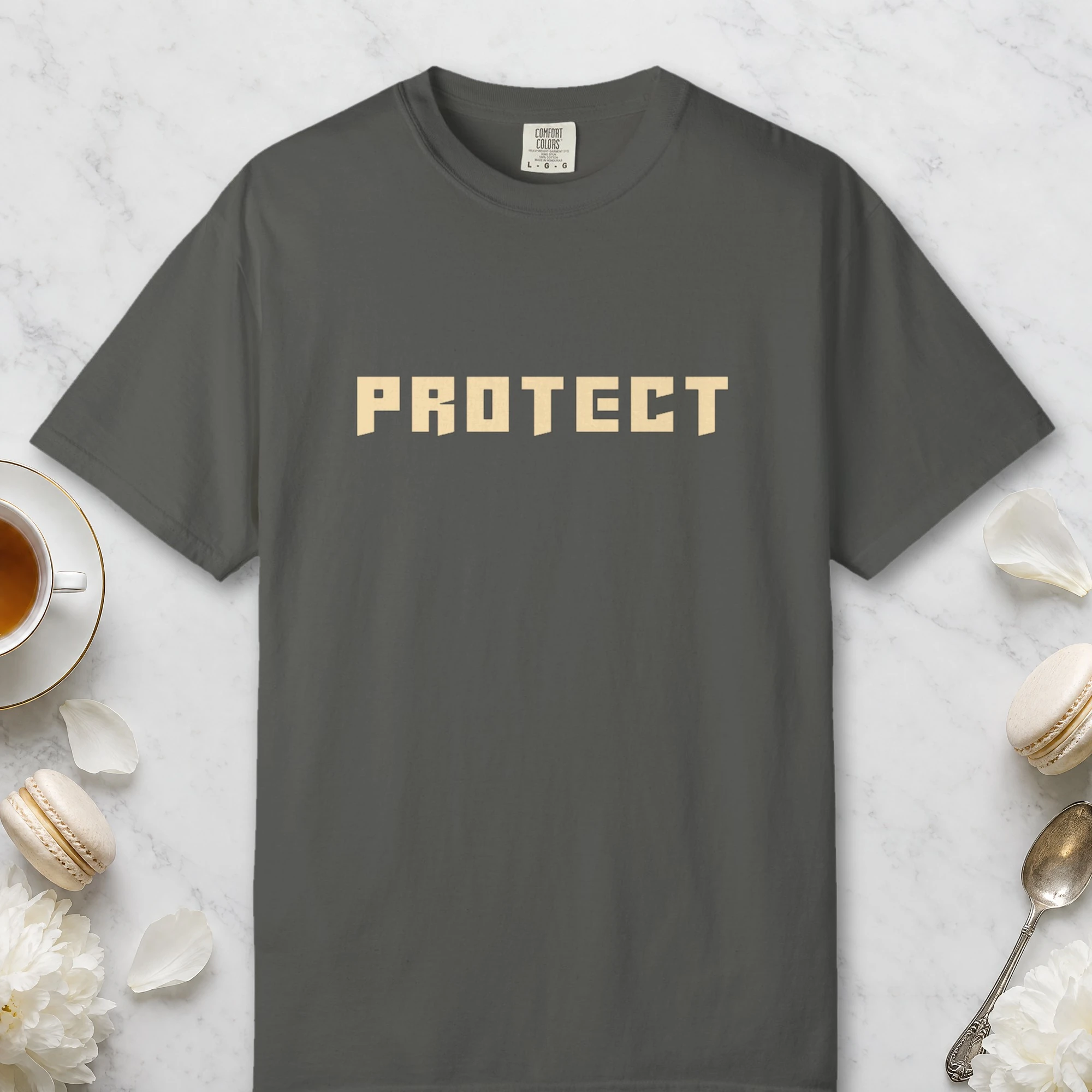 Protect design on a Pepper Comfort Colors 1717 tee, laid flat