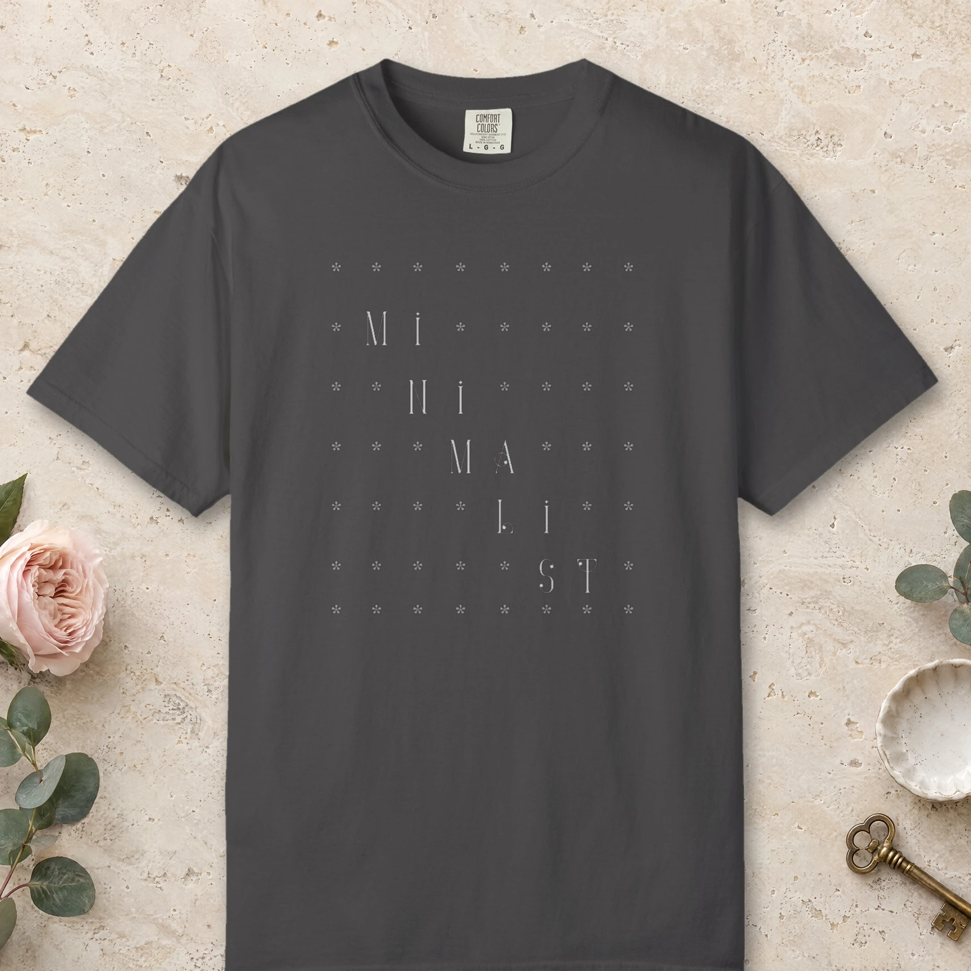 Quiet Grid design on a Graphite Comfort Colors 1717 tee, laid flat