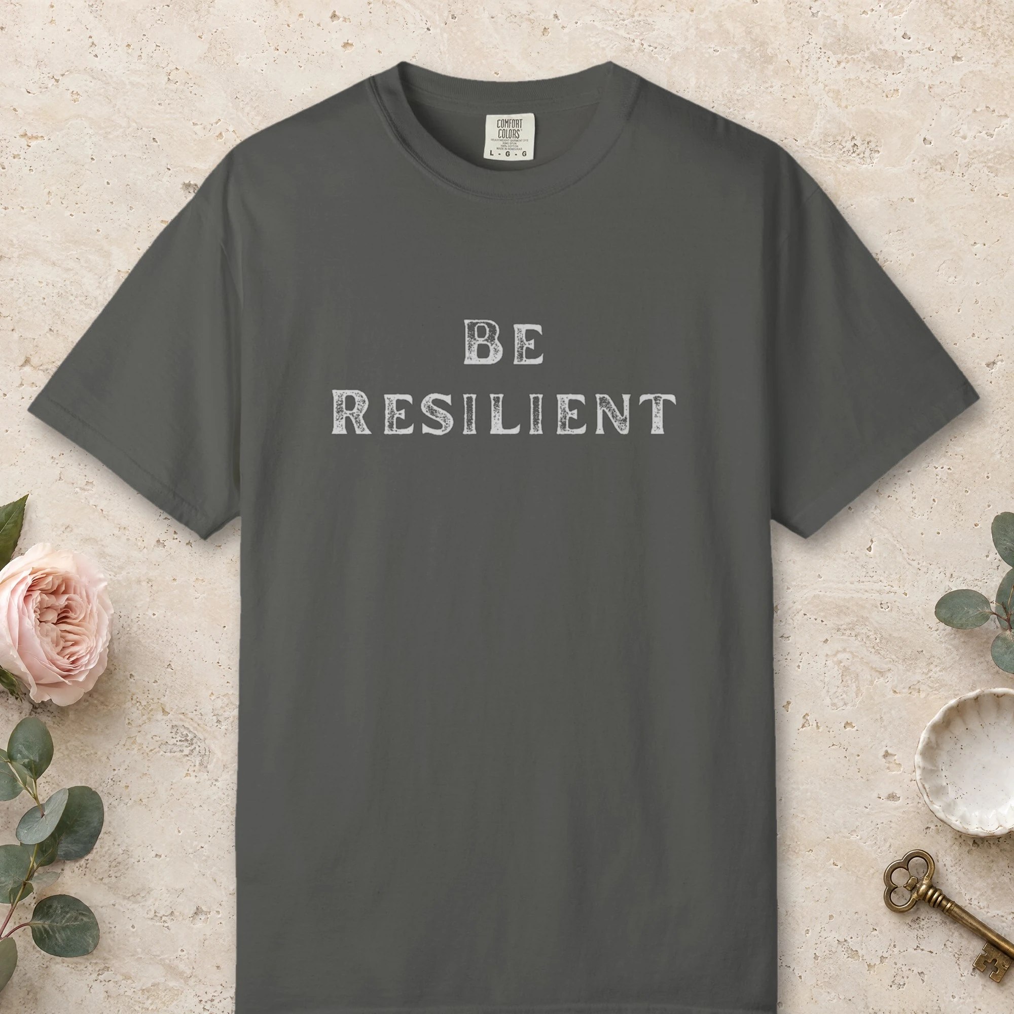 Quiet Resilience design on a Pepper Comfort Colors 1717 tee, laid flat