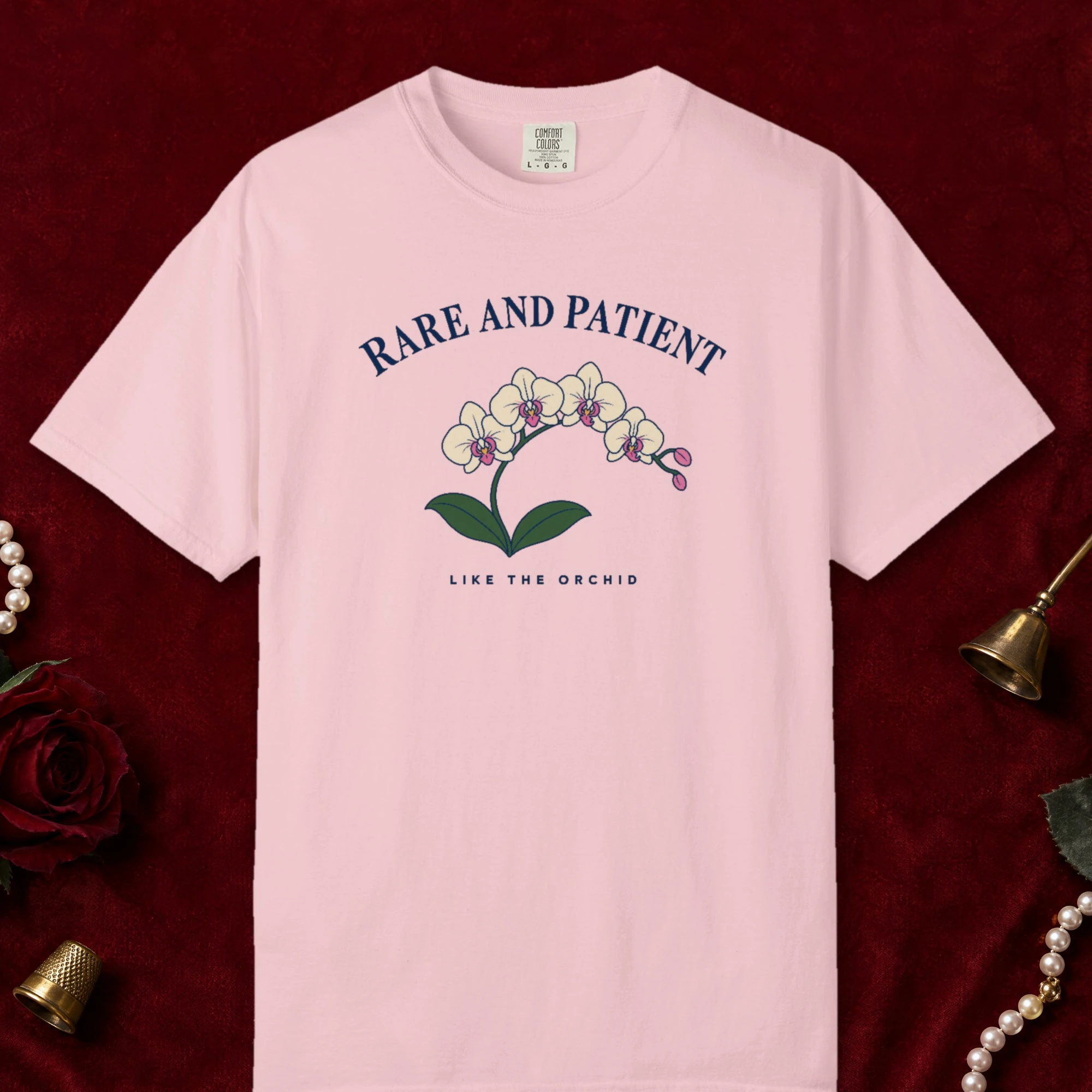 Rare and Patient design on a Blossom Comfort Colors 1717 tee, laid flat