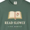read-slowly-live-gently-tee-blue-spruce-chest Close-up of the Read Slowly Live Gently print on a Blue Spruce Comfort Colors 1717 tee