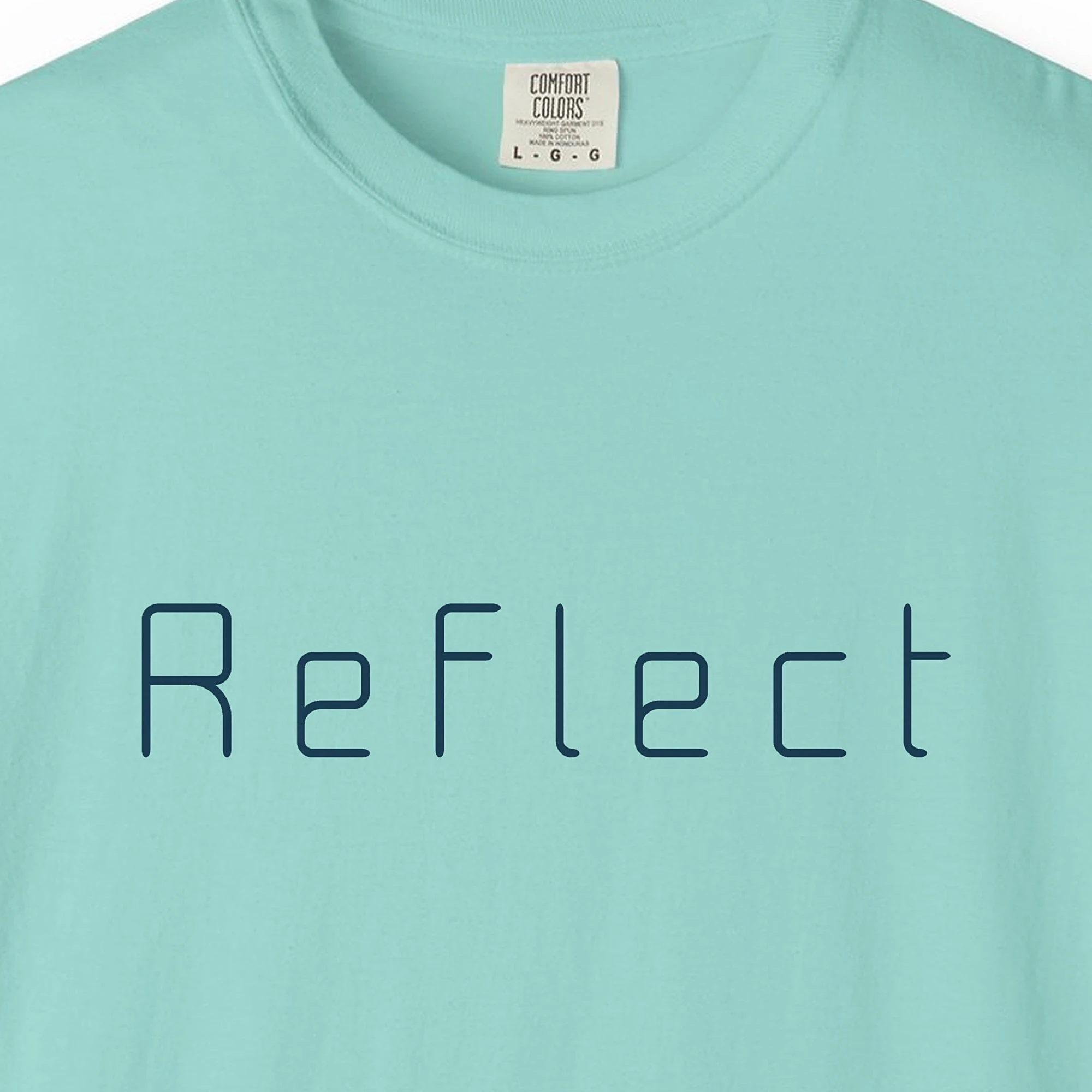 Close-up of the Reflect Square Letter print on a Chalky Mint Comfort Colors 1717 tee