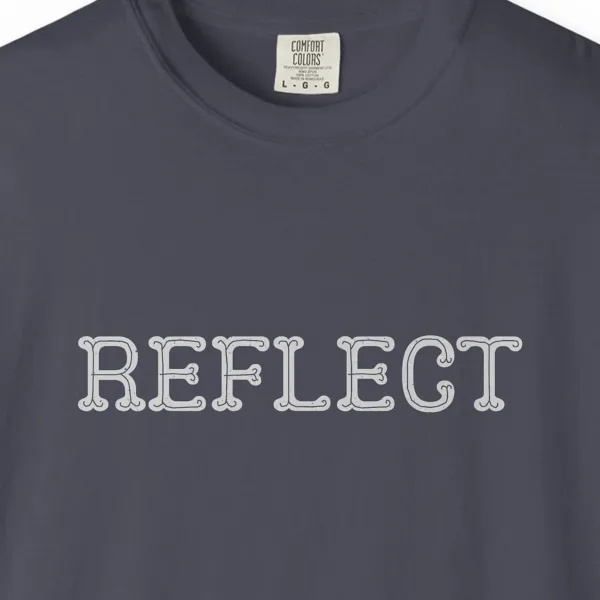 Close-up of the Reflect print on a Navy Comfort Colors 1717 tee
