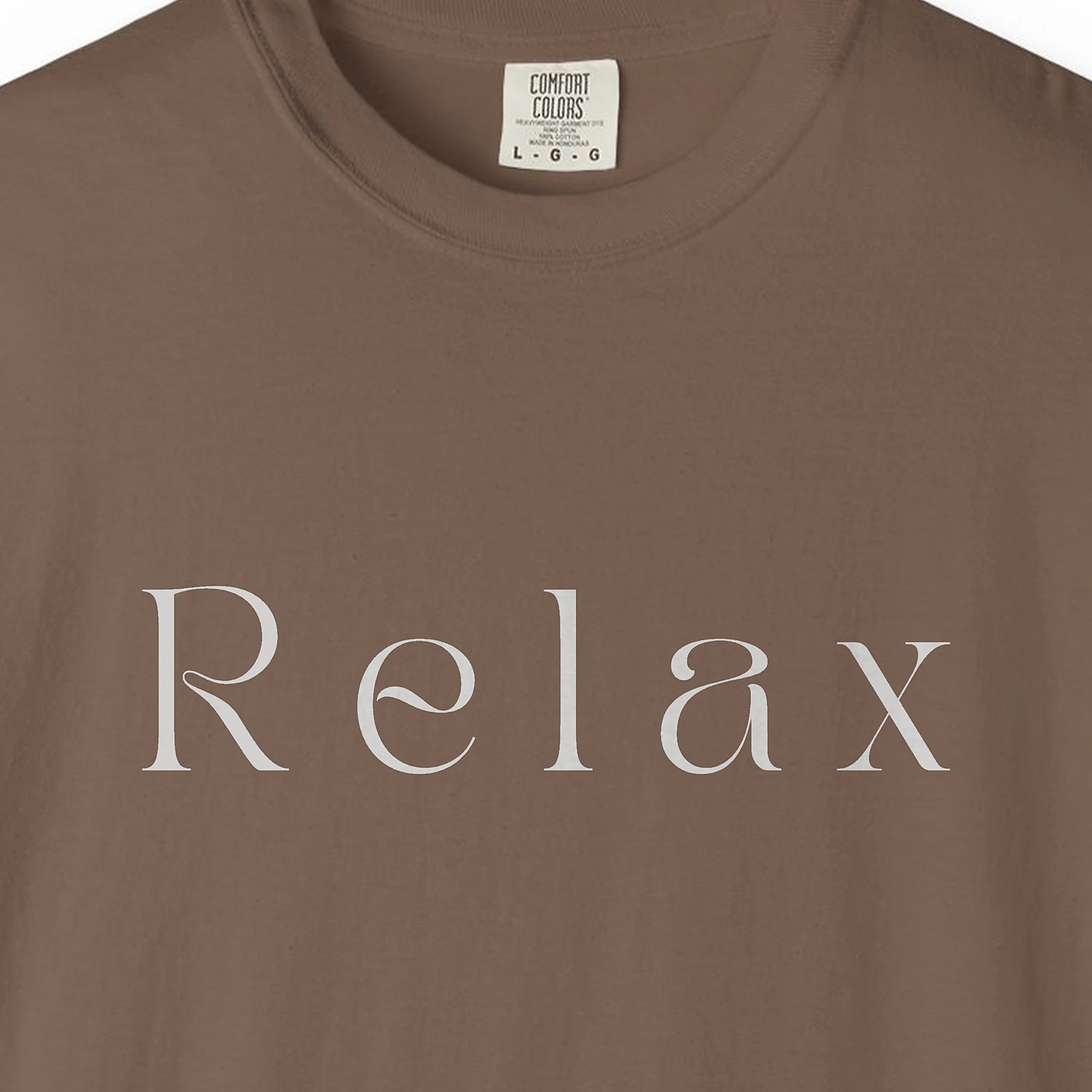 Close-up of the Relax Display Serif print on a Espresso Comfort Colors 1717 tee