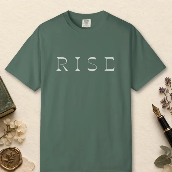 rise-bold-capitals-tee-blue-spruce-front Rise Bold Capitals design on a Blue Spruce Comfort Colors 1717 tee, laid flat