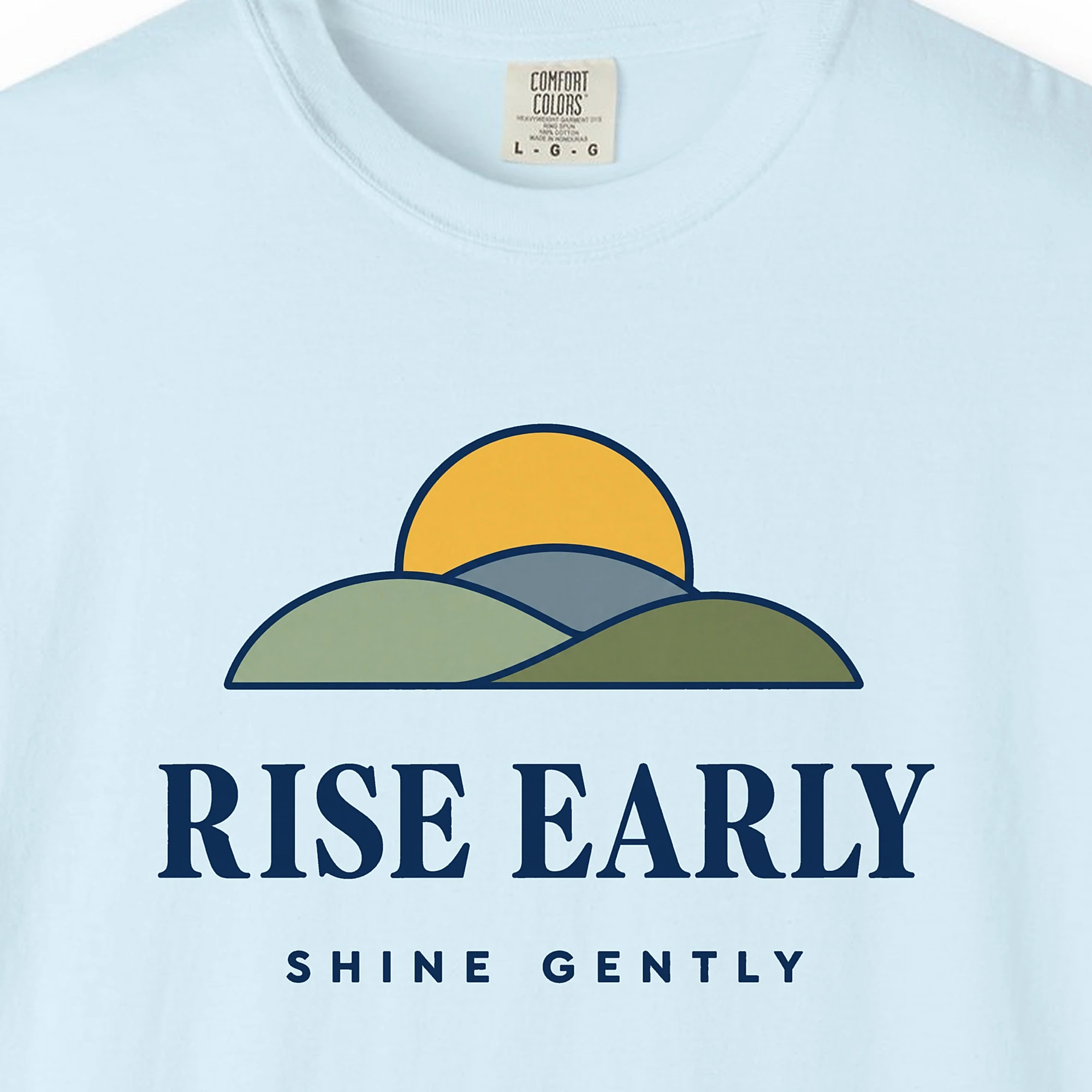 Close-up of the Rise Early Shine Gently print on a Chambray Comfort Colors 1717 tee