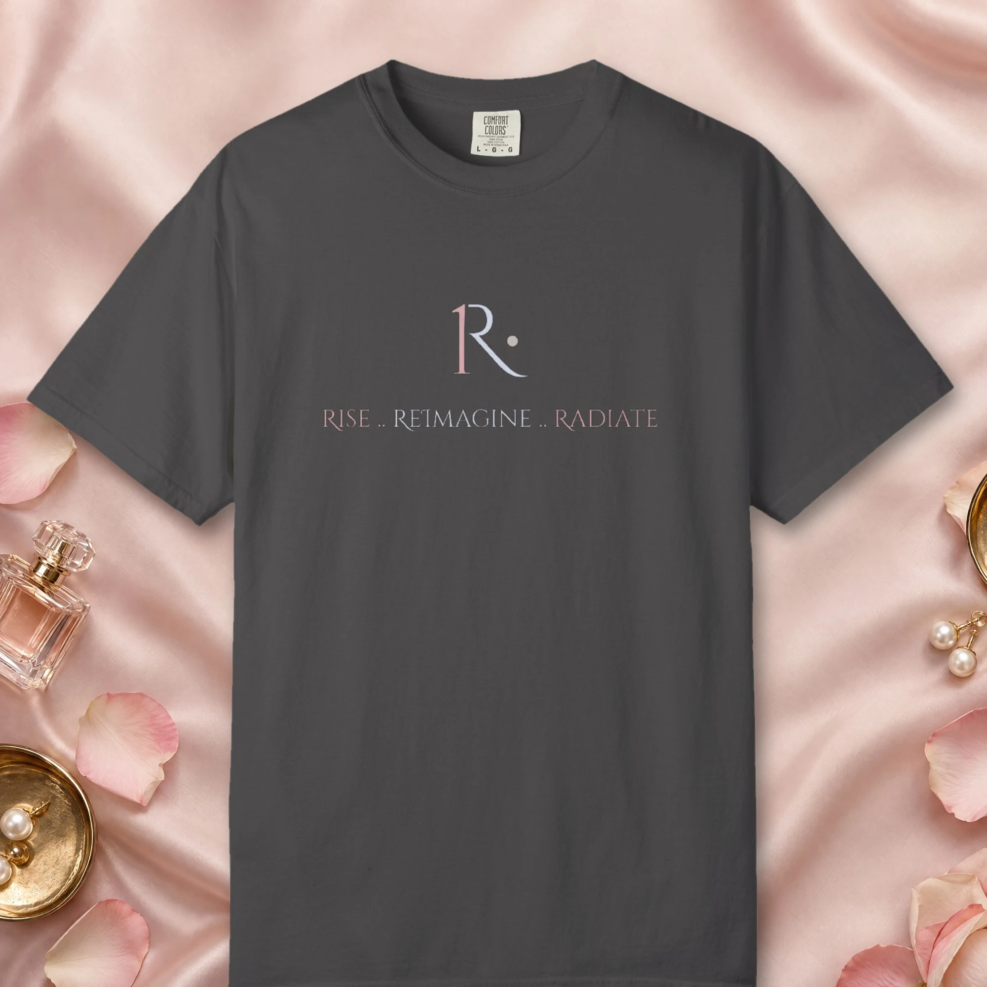 Rise Reimagine Radiate design on a Graphite Comfort Colors 1717 tee, laid flat