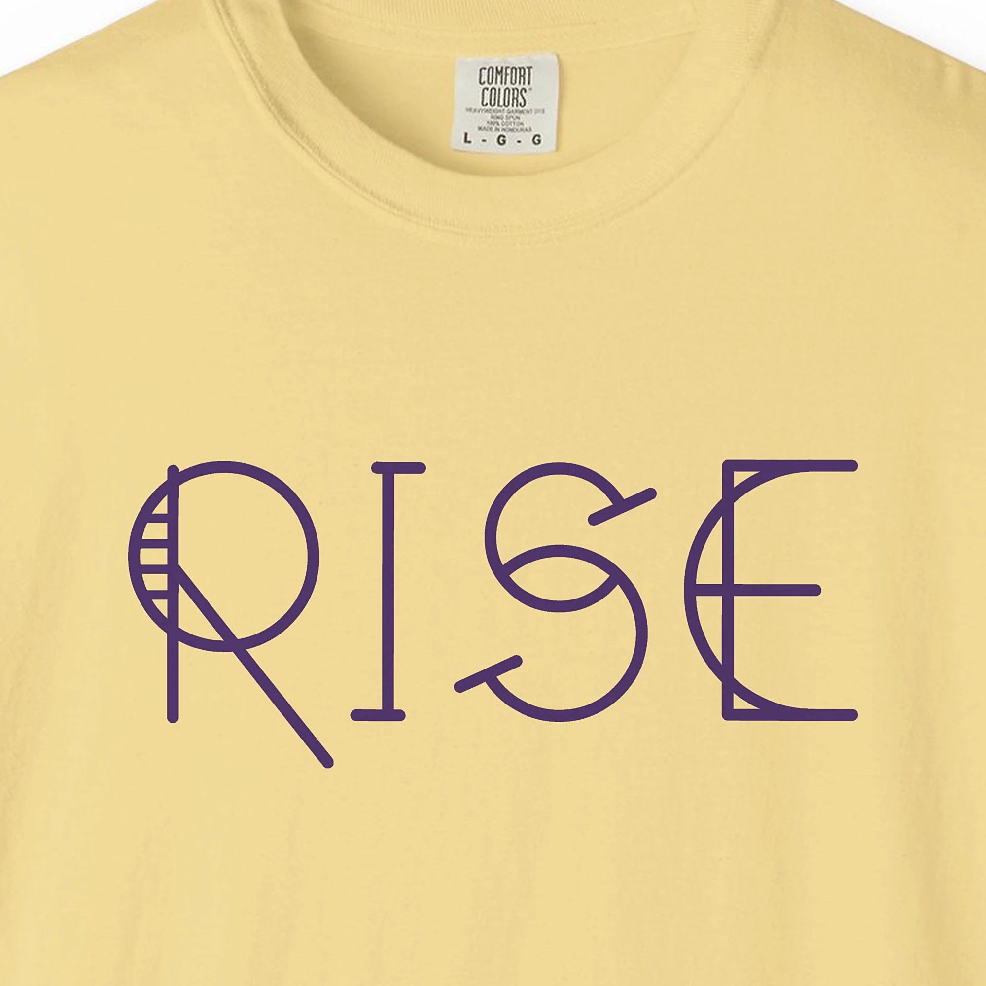 Close-up of the Rise print on a Butter Comfort Colors 1717 tee