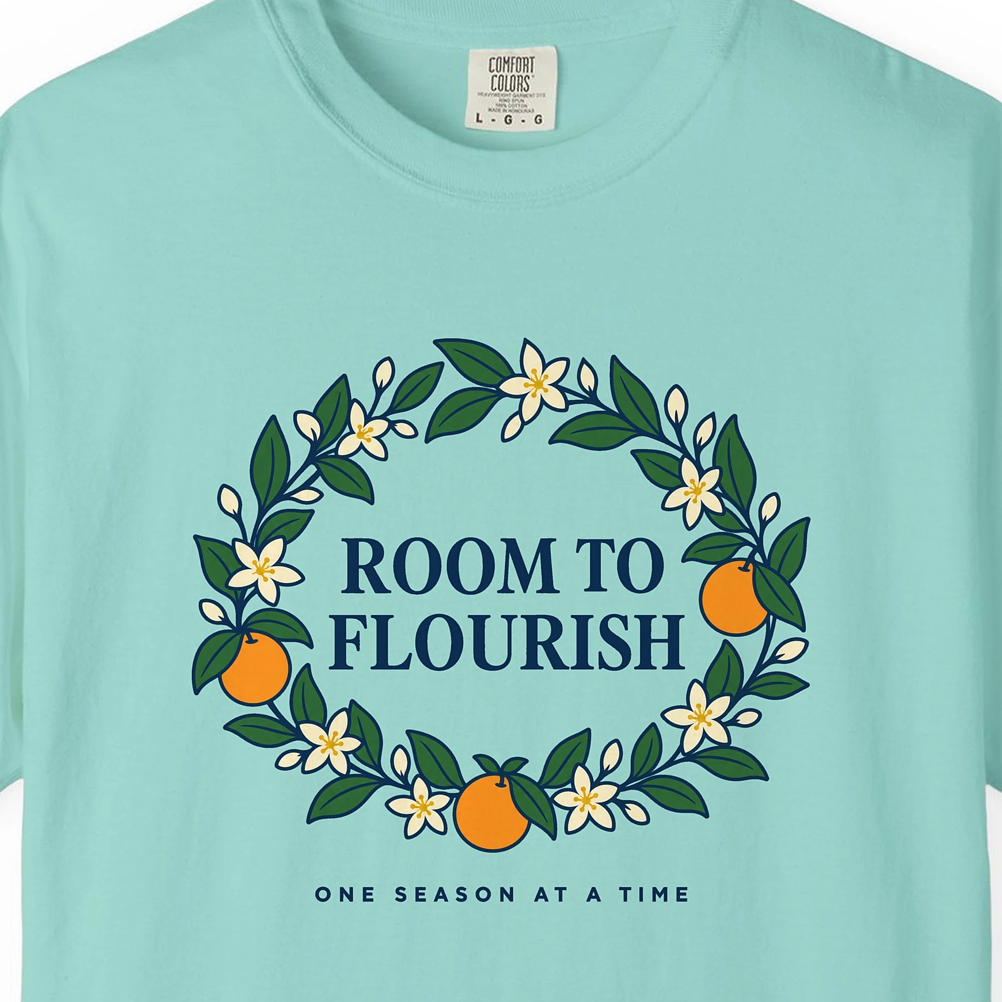 room-to-flourish-tee-chalky-mint-chest Close-up of the Room to Flourish print on a Chalky Mint Comfort Colors 1717 tee