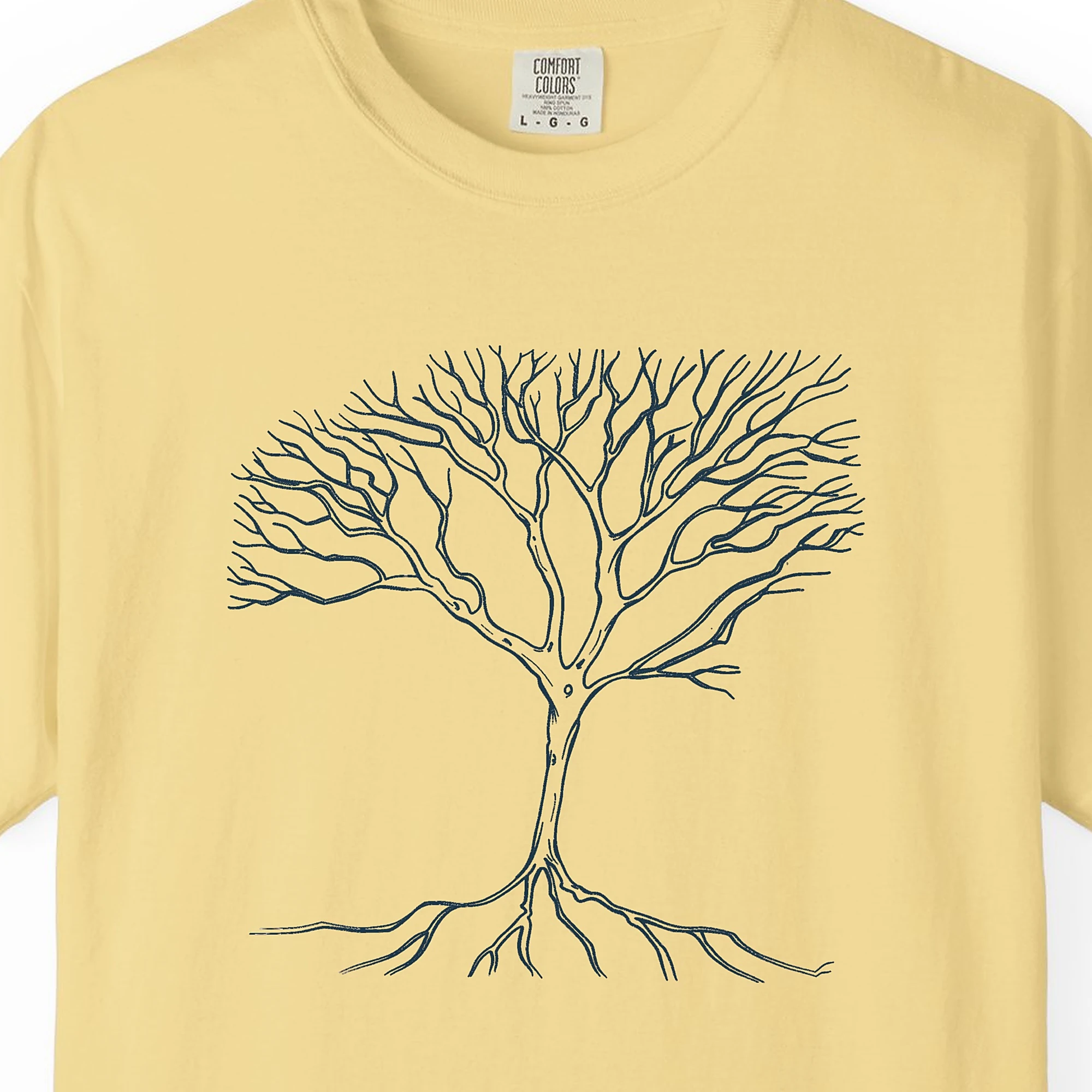 Close-up of the Roots and Branches print on a Butter Comfort Colors 1717 tee