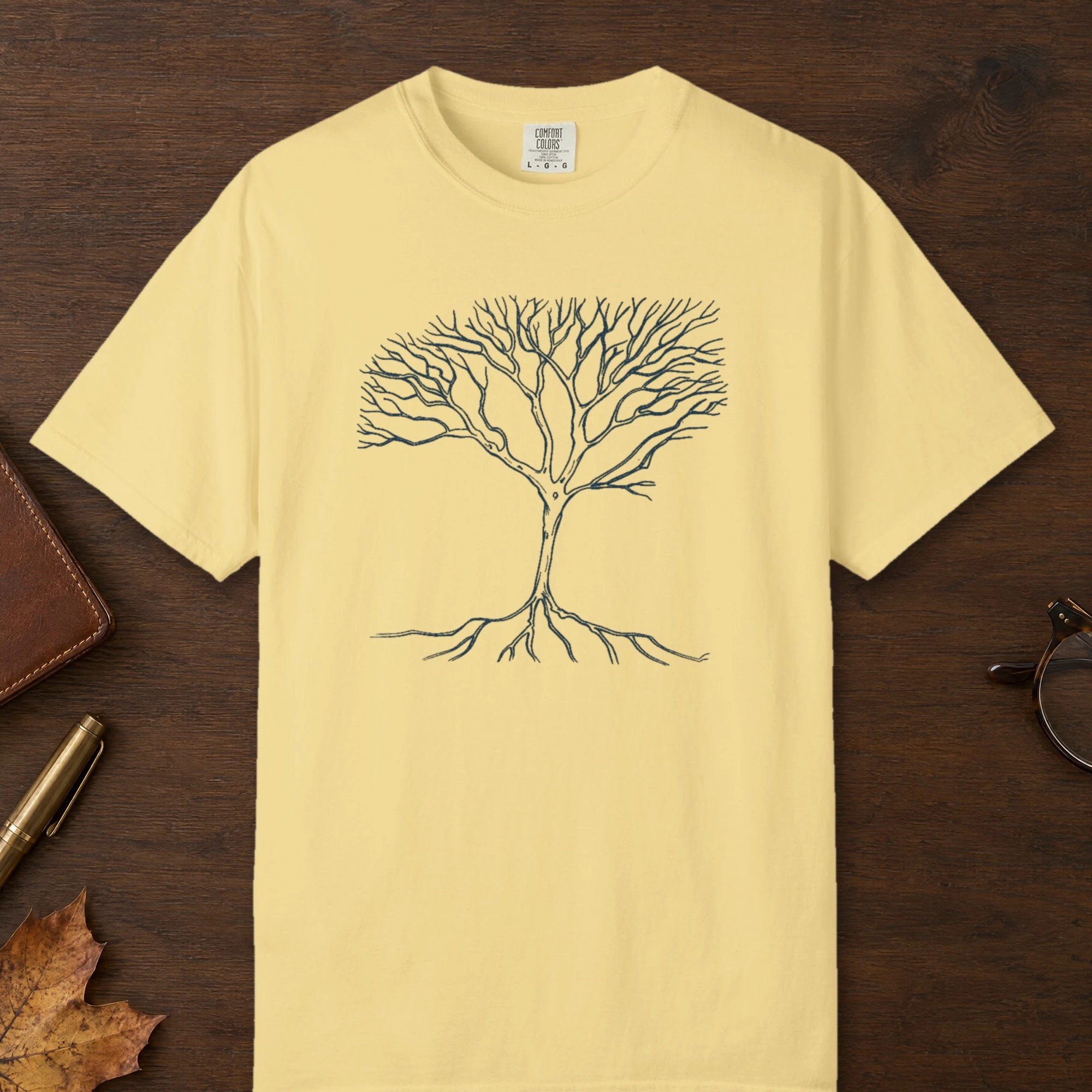 Roots and Branches design on a Butter Comfort Colors 1717 tee, laid flat
