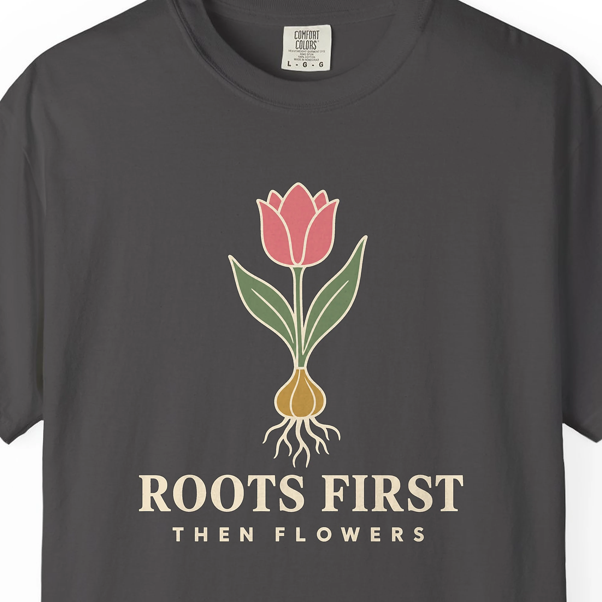 roots-first-tee-graphite-chest Close-up of the Roots First print on a Graphite Comfort Colors 1717 tee