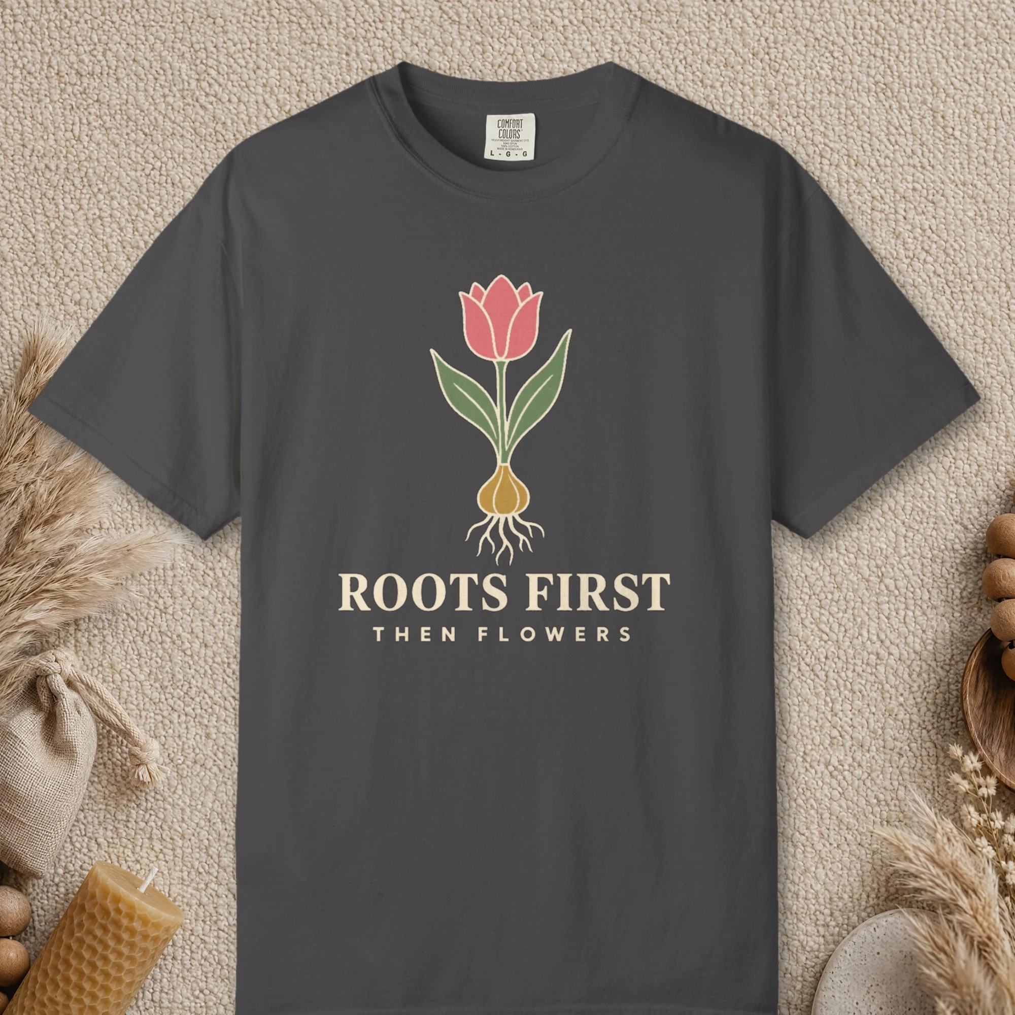 Roots First design on a Graphite Comfort Colors 1717 tee, laid flat