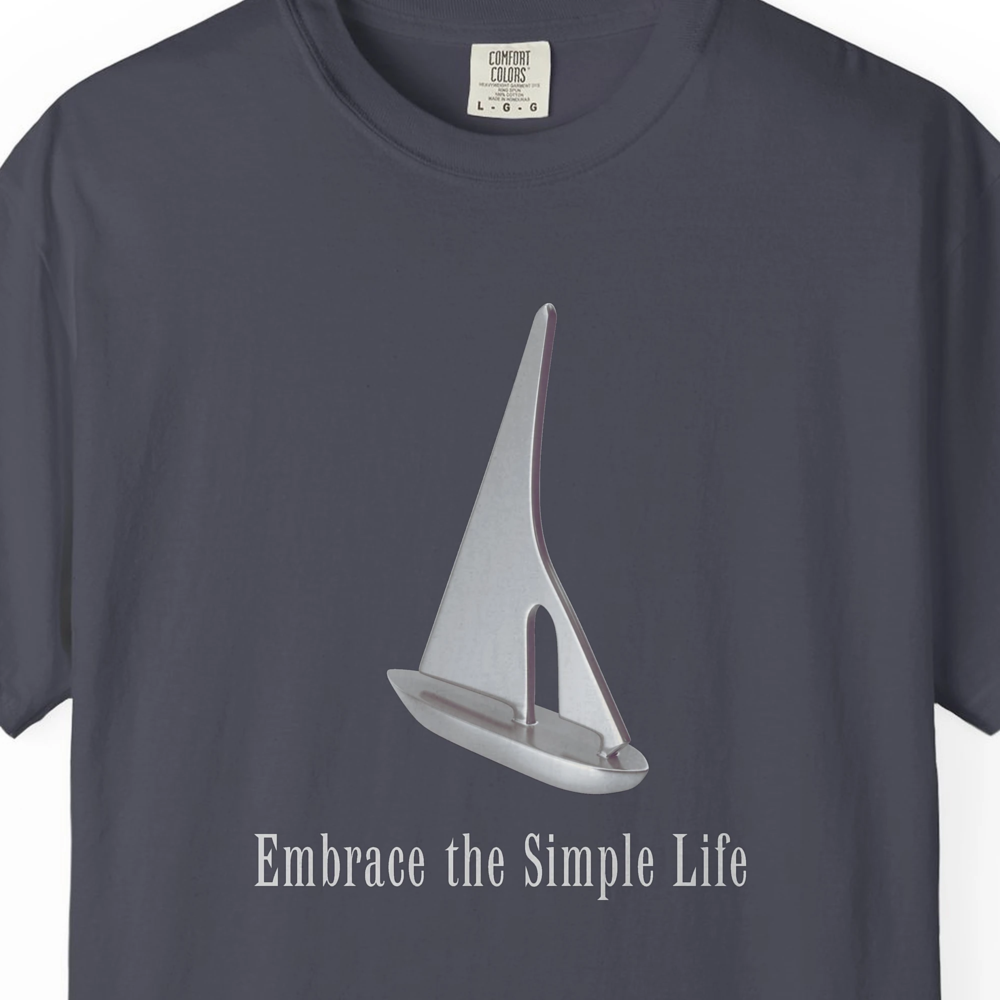 silver-sailboat-tee-navy-chest Close-up of the Silver Sailboat print on a Navy Comfort Colors 1717 tee