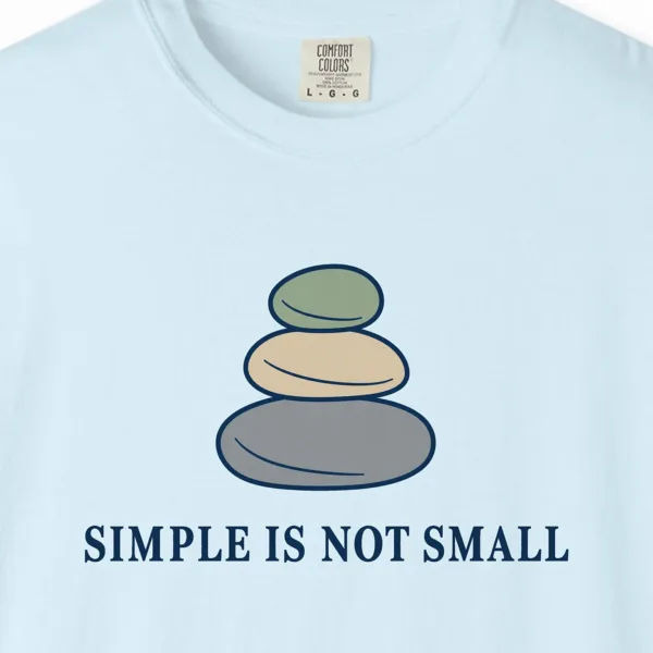 Close-up of the Simple Is Not Small print on a Chambray Comfort Colors 1717 tee