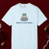 Simple Is Not Small design on a Chambray Comfort Colors 1717 tee, laid flat