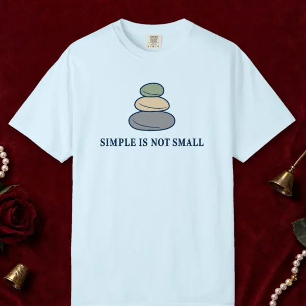 Simple Is Not Small design on a Chambray Comfort Colors 1717 tee, laid flat
