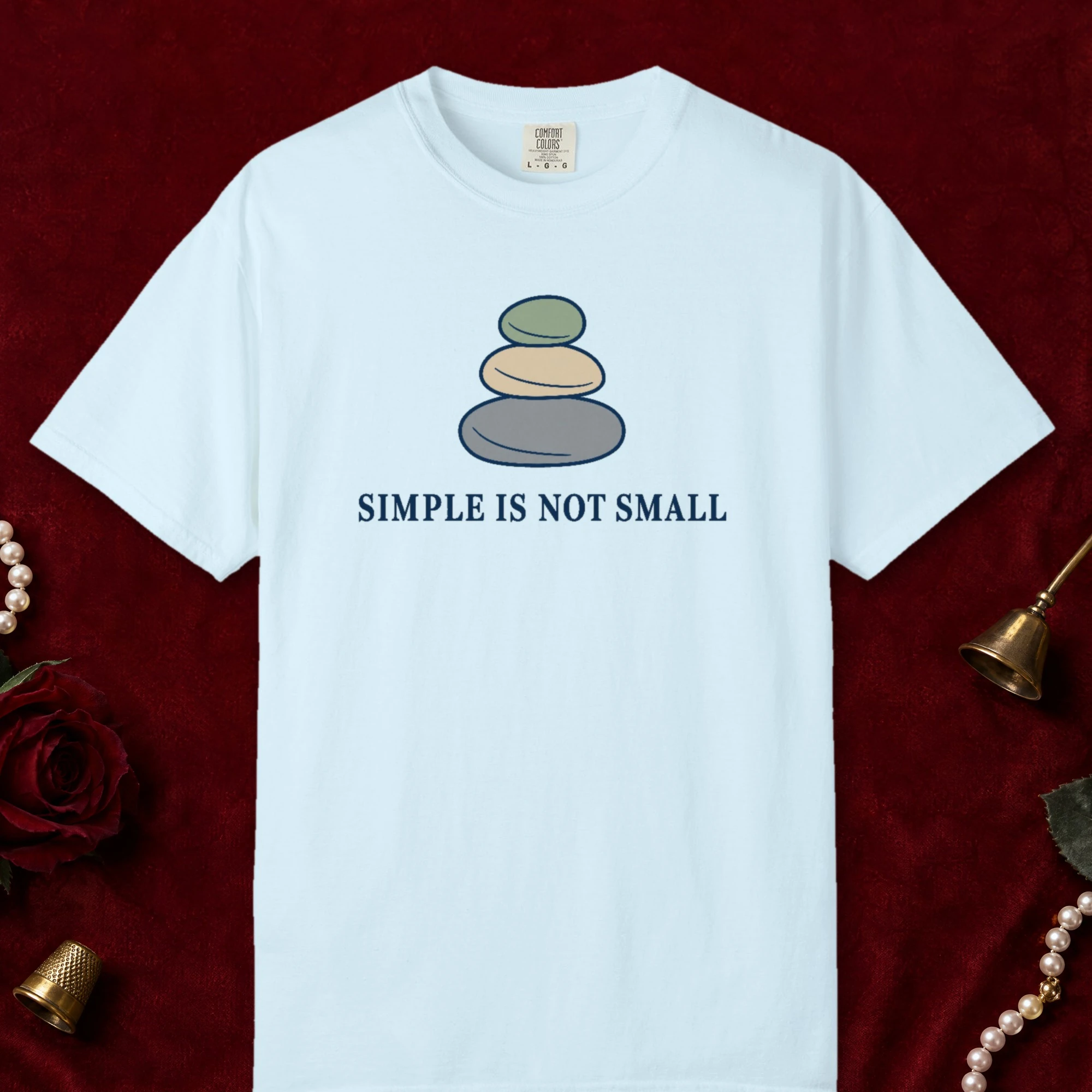 Simple Is Not Small design on a Chambray Comfort Colors 1717 tee, laid flat