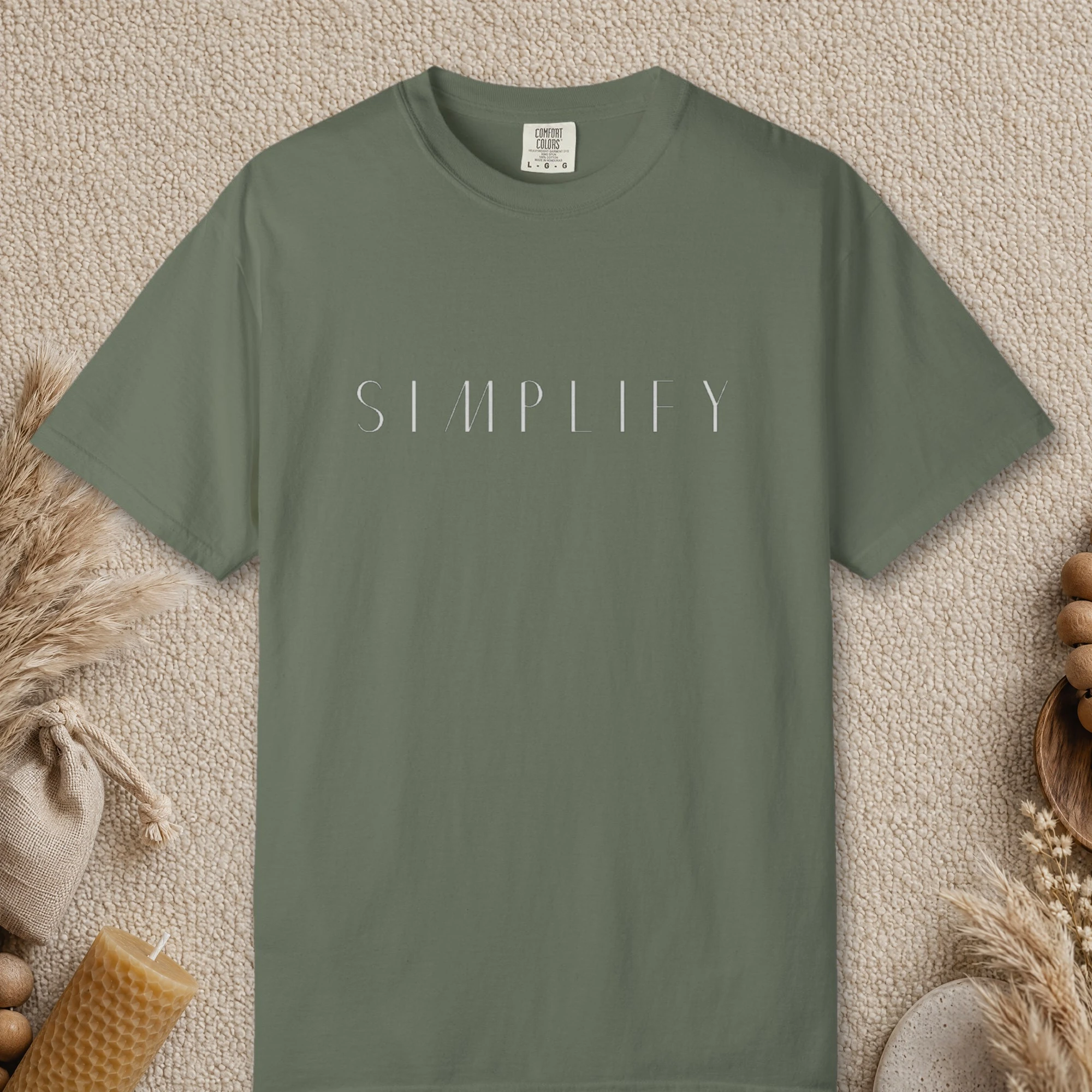Simplify Spaced Capitals design on a Moss Comfort Colors 1717 tee, laid flat