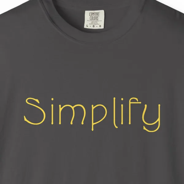 simplify-tee-graphite-chest Close-up of the Simplify print on a Graphite Comfort Colors 1717 tee