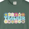 Close-up of the Smiling Daisies Teacher print on a Blue Spruce Comfort Colors 1717 tee