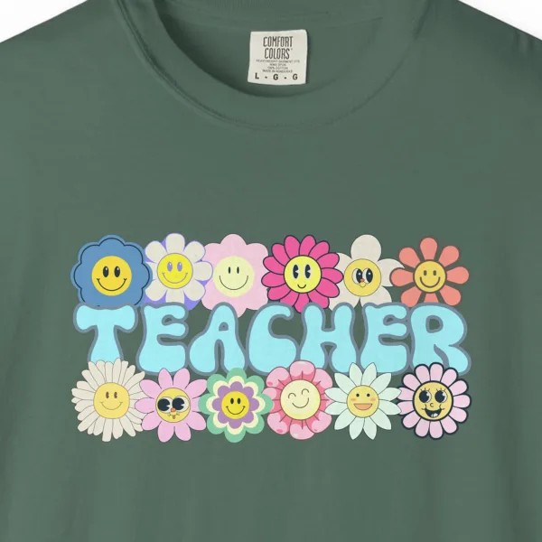 Close-up of the Smiling Daisies Teacher print on a Blue Spruce Comfort Colors 1717 tee