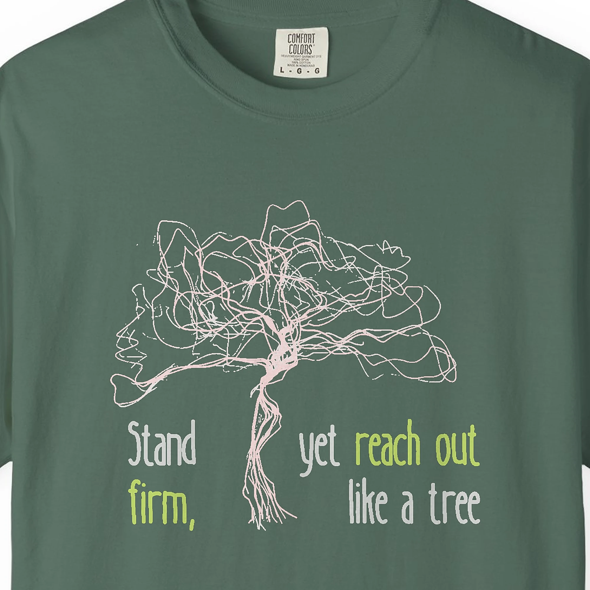 Close-up of the Stand Firm Reach Out print on a Blue Spruce Comfort Colors 1717 tee