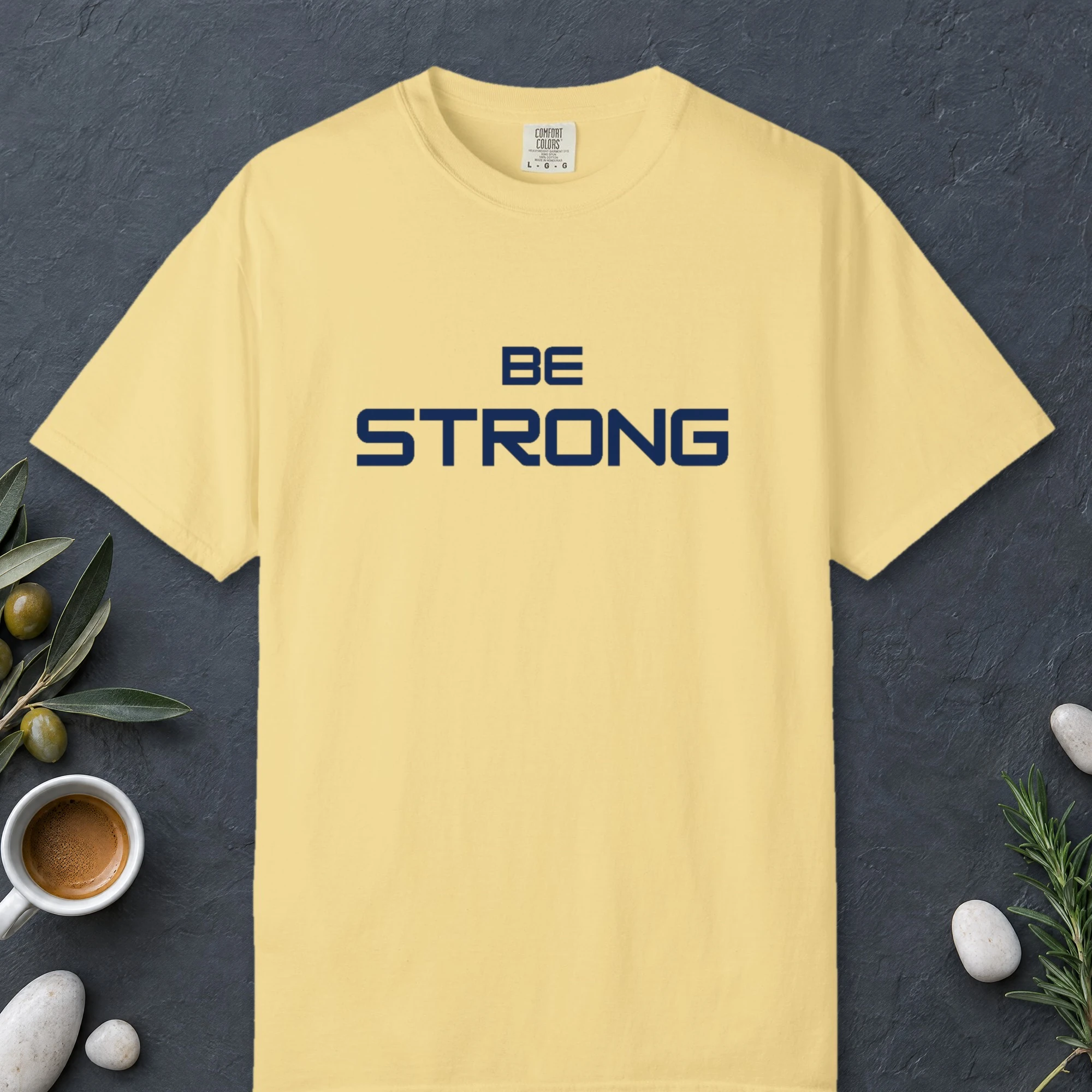 Steady Strength design on a Butter Comfort Colors 1717 tee, laid flat