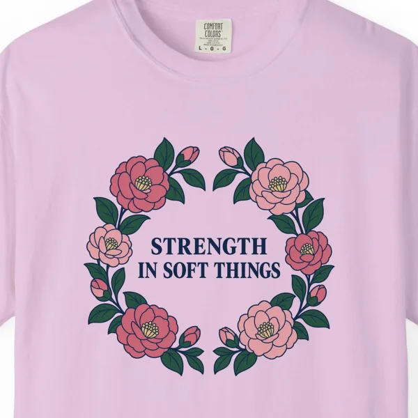 Close-up of the Strength in Soft Things print on a Orchid Comfort Colors 1717 tee