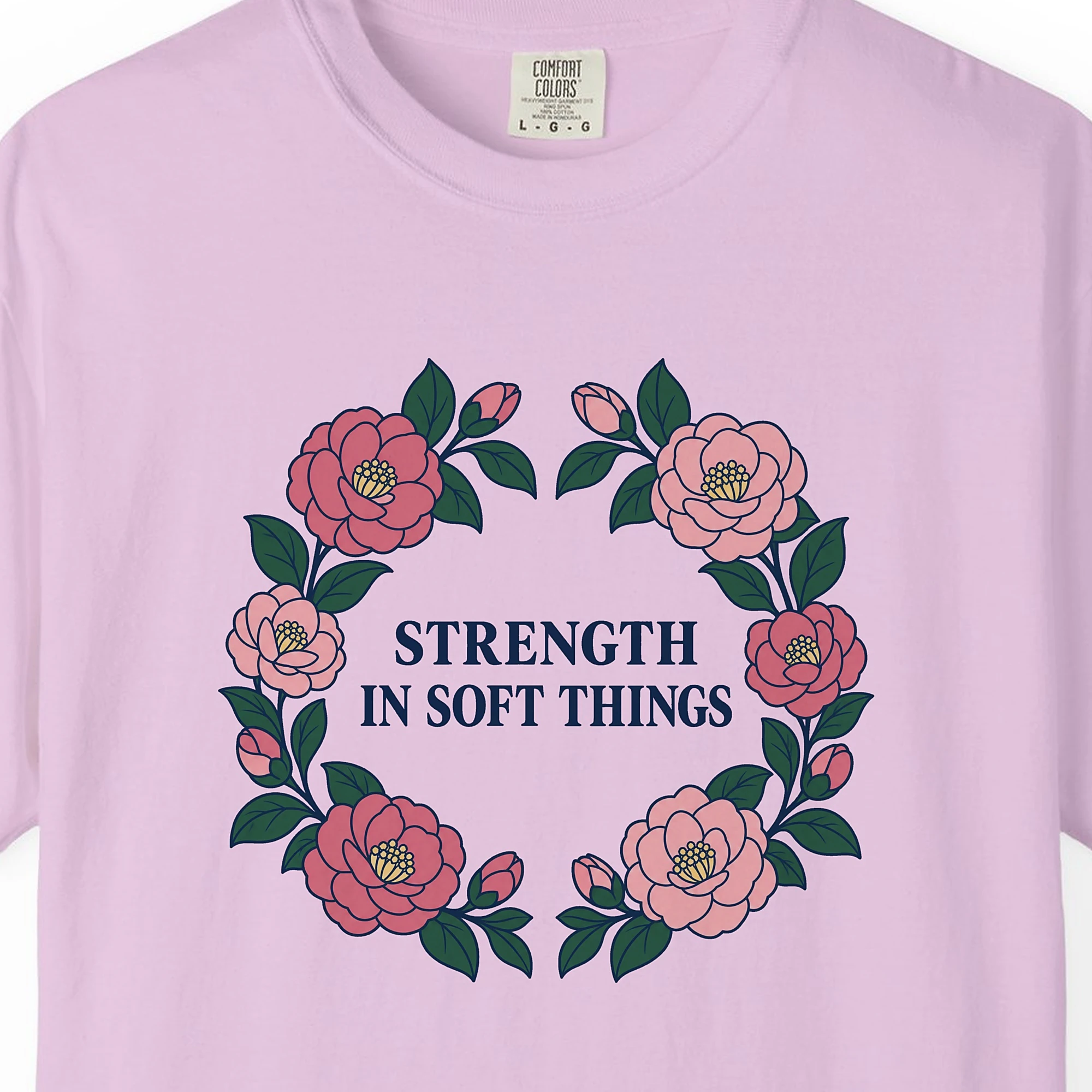 Close-up of the Strength in Soft Things print on a Orchid Comfort Colors 1717 tee