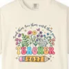 Close-up of the Teach Them Love Them print on a Ivory Comfort Colors 1717 tee