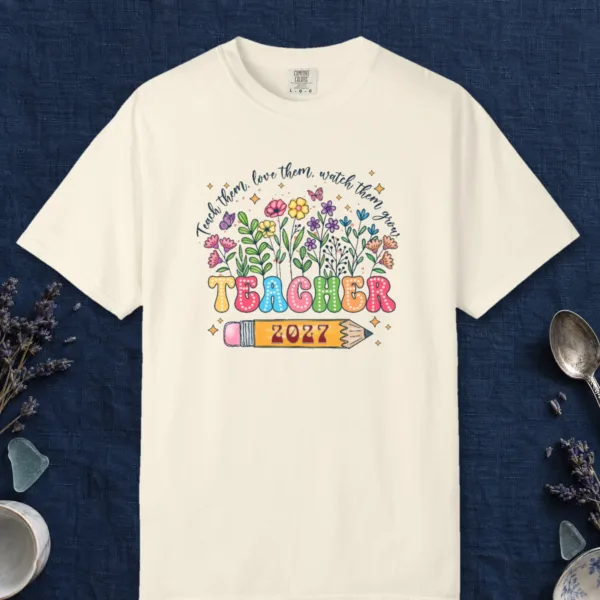 Teacher in Bloom design on a Ivory Comfort Colors 1717 tee, laid flat