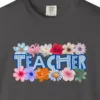 teacher-in-flowers-tee-graphite-chest Close-up of the Teacher in Flowers print on a Graphite Comfort Colors 1717 tee