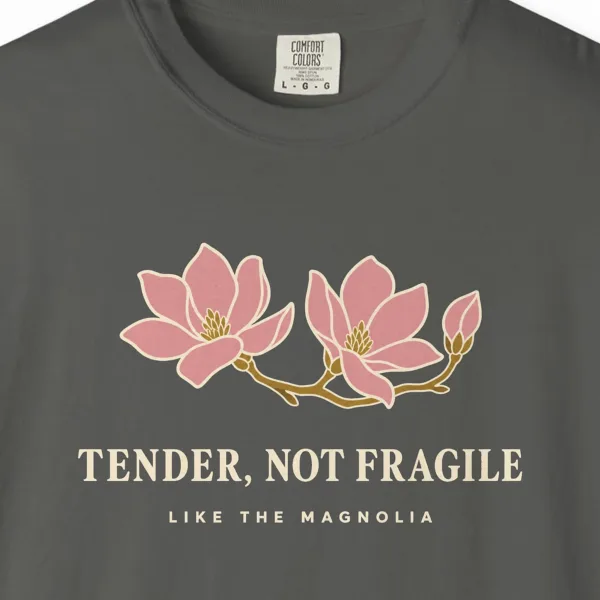 tender-not-fragile-tee-pepper-chest Close-up of the Tender Not Fragile print on a Pepper Comfort Colors 1717 tee