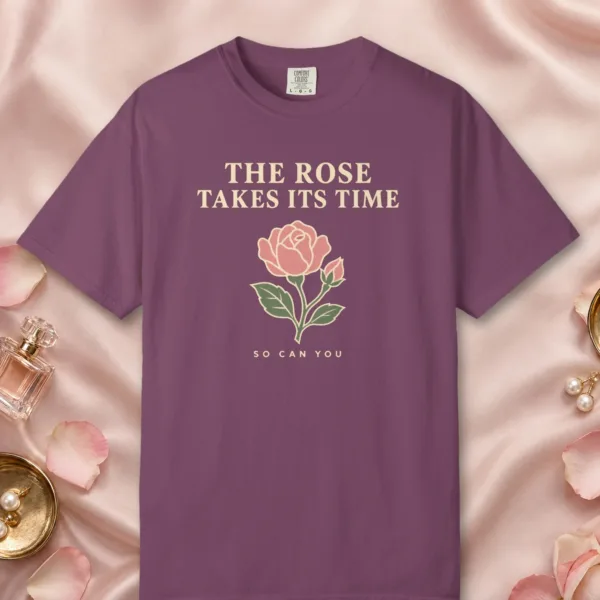 The Rose Takes Its Time design on a Berry Comfort Colors 1717 tee, laid flat