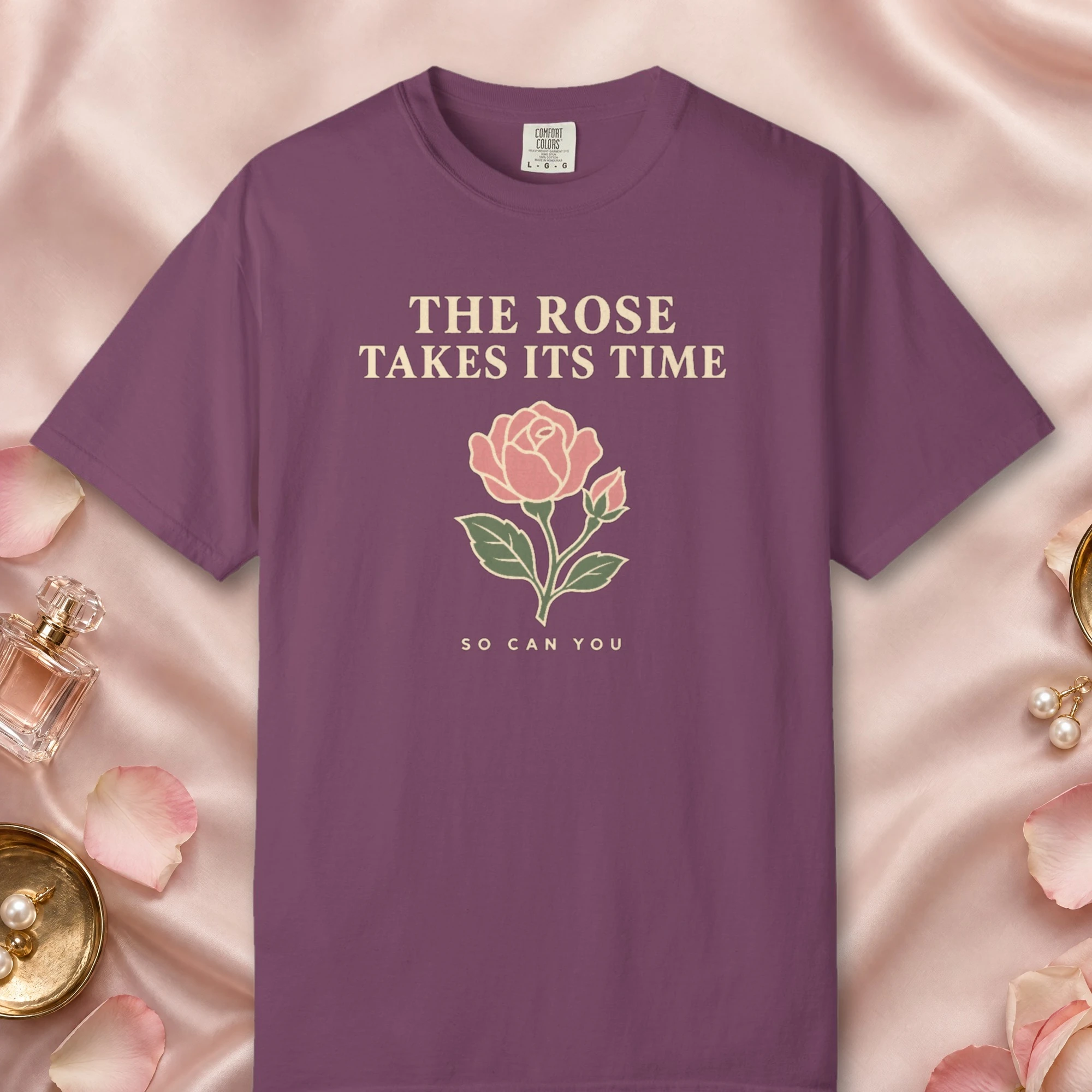 The Rose Takes Its Time design on a Berry Comfort Colors 1717 tee, laid flat