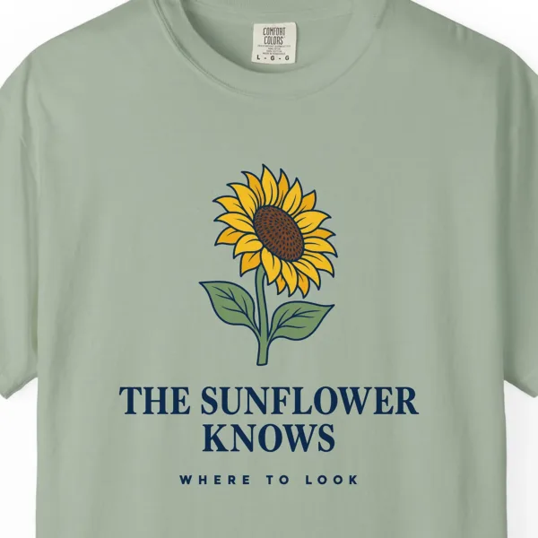 the-sunflower-knows-tee-bay-chest Close-up of the The Sunflower Knows print on a Bay Comfort Colors 1717 tee