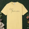 Thrive Handwritten design on a Butter Comfort Colors 1717 tee, laid flat