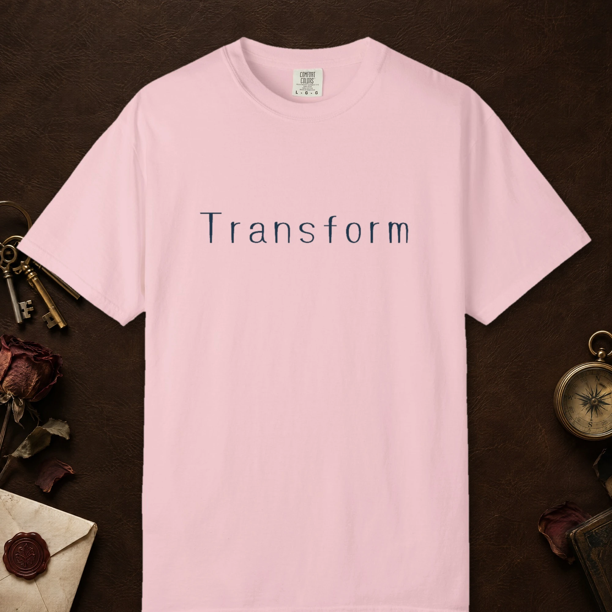 Transform Fine Line design on a Blossom Comfort Colors 1717 tee, laid flat